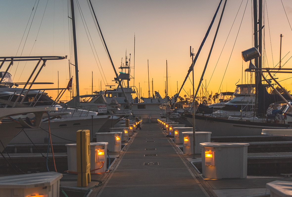 Boats docked at sunset