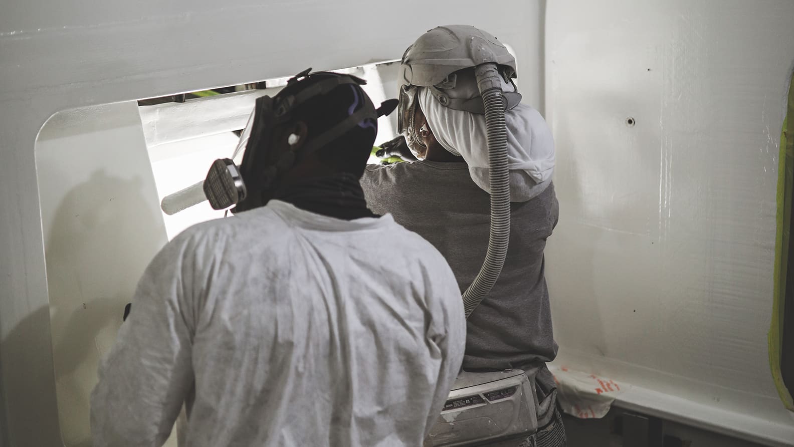 team repairing fiberglass